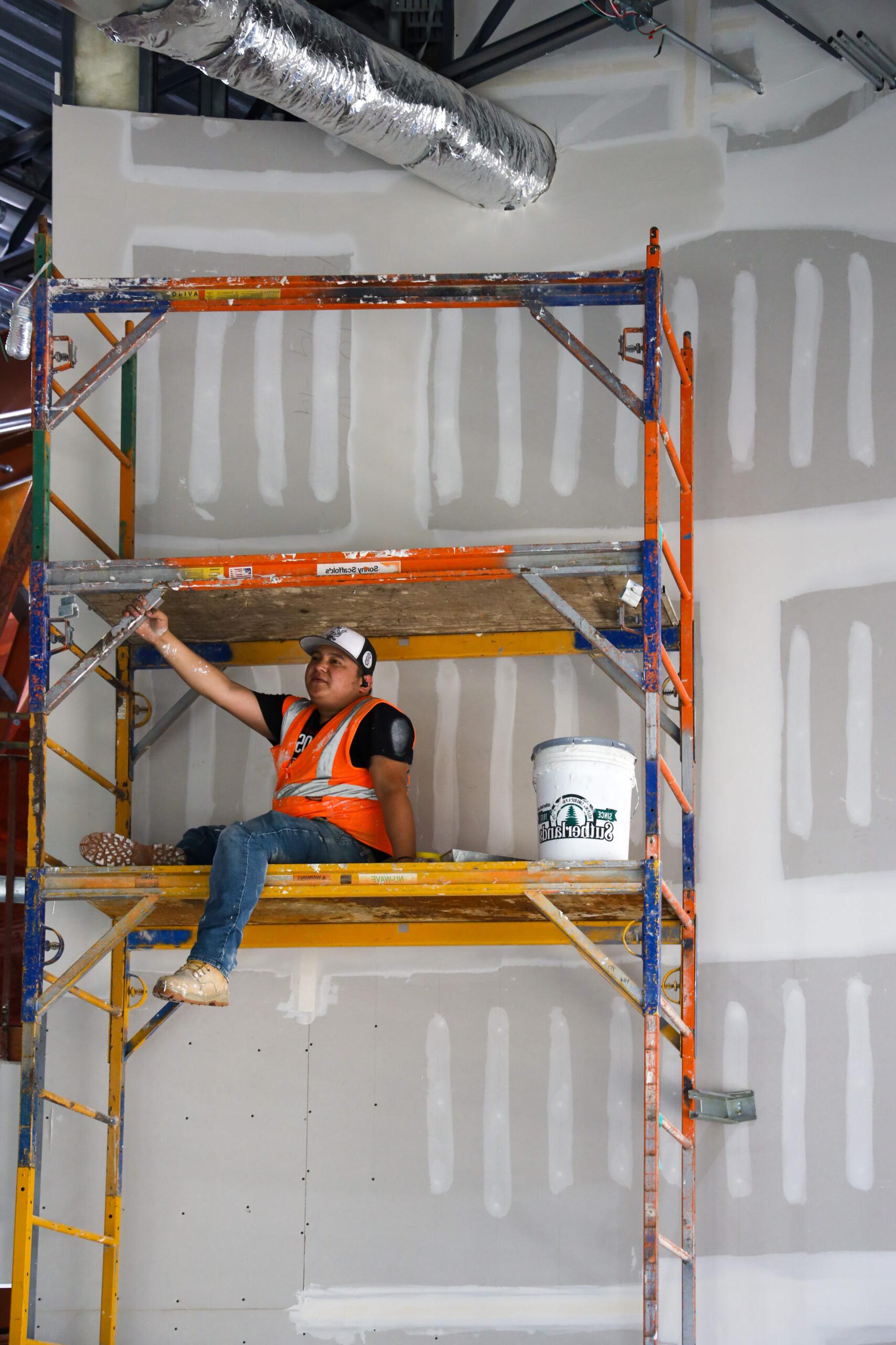 Man sitting on scaffolding